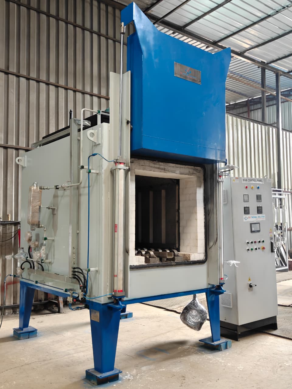 Open chamber of a pit type tempering furnace showing insulation and loaded components at SR Thermal Solution