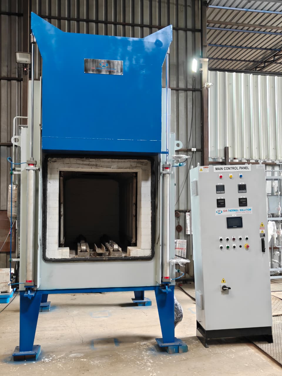 Pit type tempering furnace with vertical loading and open insulated cover manufactured by SR Thermal Solution
